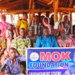 MOK Foundation representative distributing cash to underprivileged individuals in Shangbe, Ifelodun LG.